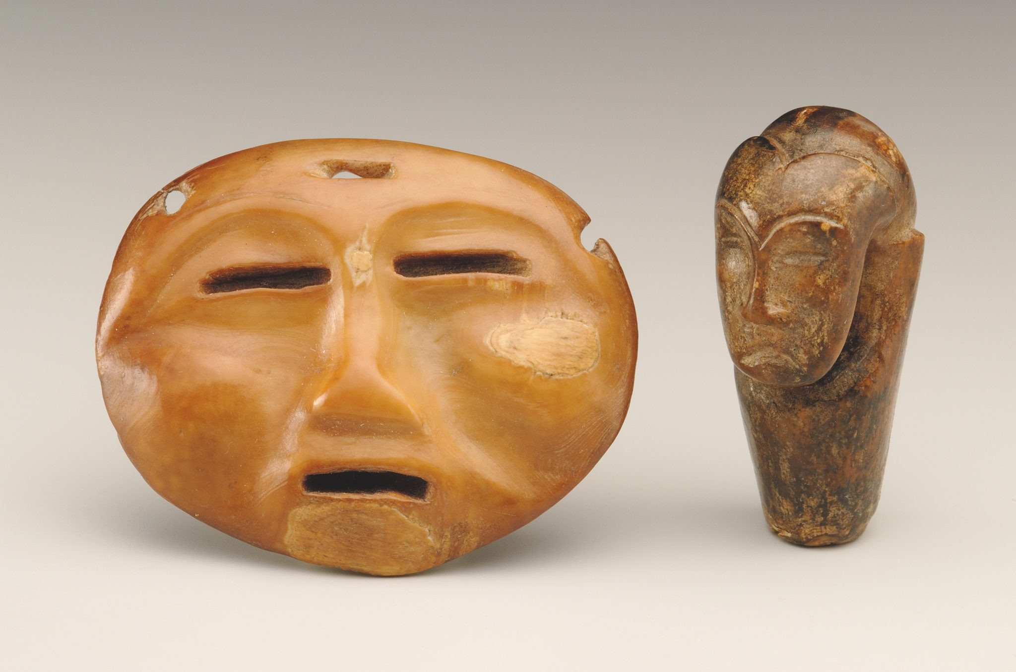 Mask-like object and janiform pendant (?) from the ancient Eskimo burial site Ekven (Old Bering Sea culture, OBS II). Material: walrus tusk. State Museum of Oriental Art, Moscow (photo Ye. Zheltov)